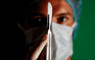 The surgeon prepares for an operation to increase the member
